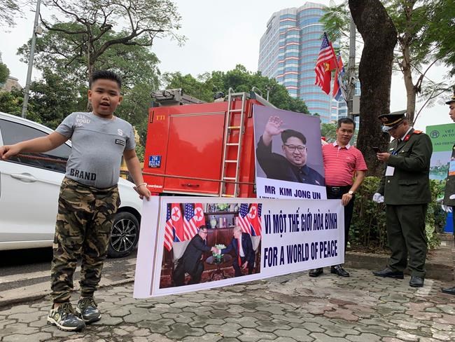 Pham Quang Dung, 8years old, wearing a hairstyle of North Korean leader Kim Jong Un, holds a placard that reads “For a World of Peace” with his father Pham Quang Trung, right, near a Hanoi hotel where Kim stays on Wednesday, Feb. 27, 2019, Hanoi, Vietnam. Kim and U.S. President Donald Trump are expected to meet for their second summit Feb. 27 and 28 in Hanoi. (AP Photo/Joeal Calupitan)