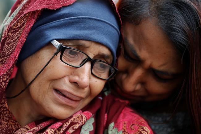 A woman who lost her husband during Friday's mass shootings cries outside an information center for families, Saturday, March 16, 2019, in Christchurch, New Zealand. (AP Photo/Vincent Thian)