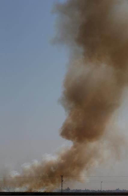 In this photo taken from the Turkish side of the border between Turkey and Syria, in Akcakale, Sanliurfa province, southeastern Turkey, smoke billows from fires on targets in Tel Abyad, Syria, caused by bombardment by Turkish forces, Sunday, Oct. 13, 2019. The United Nations says at least 130,000 people have been displaced by the fighting in northeastern Syria with many more likely on the move as a Turkish offensive in the area enters its fifth day.(AP Photo/Lefteris Pitarakis)
