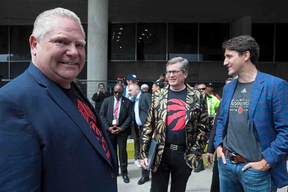 CHRIS YOUNG / THE CANADIAN PRESS FILES Ontario Premier Doug Ford (left) looks over as Prime Minister Justin Trudeau stands with Toronto Mayor John Tory, during the 2019 Toronto Raptors Championship parade in Toronto, on Monday, June 17, 2019.