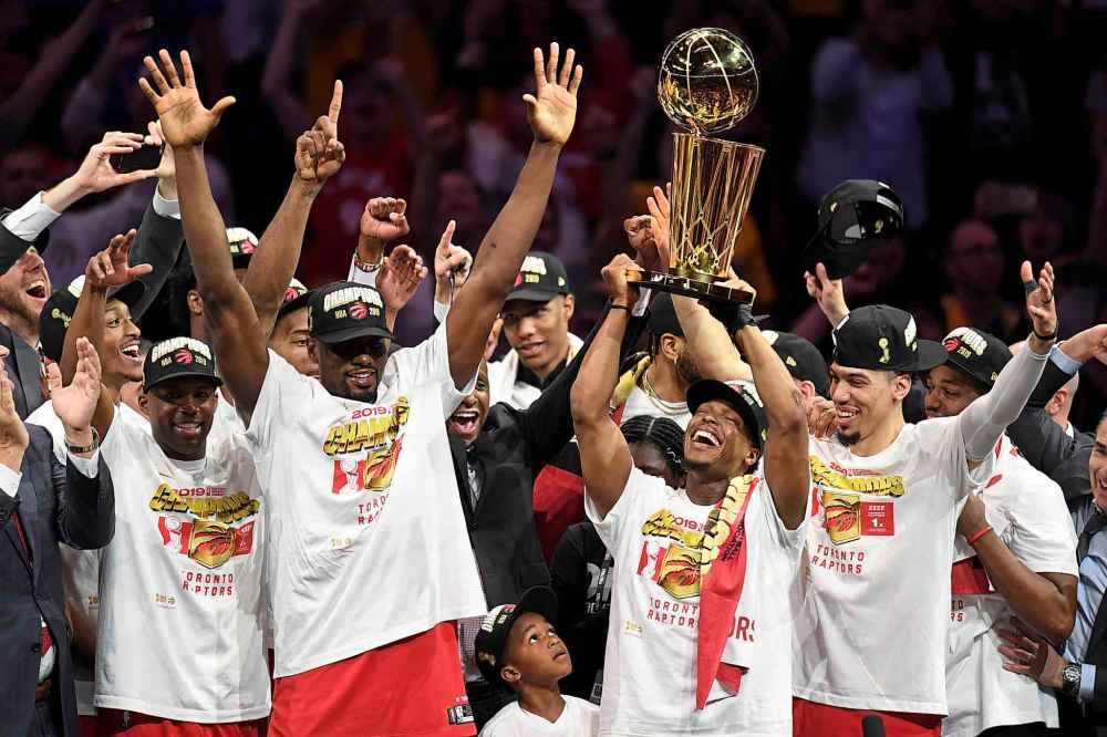 Frank Gunn / THE CANADIAN PRESS
Toronto Raptors guard Kyle Lowry, centre left, holds Larry O'Brien NBA Championship Trophy after defeating the Golden State Warriors in six games.