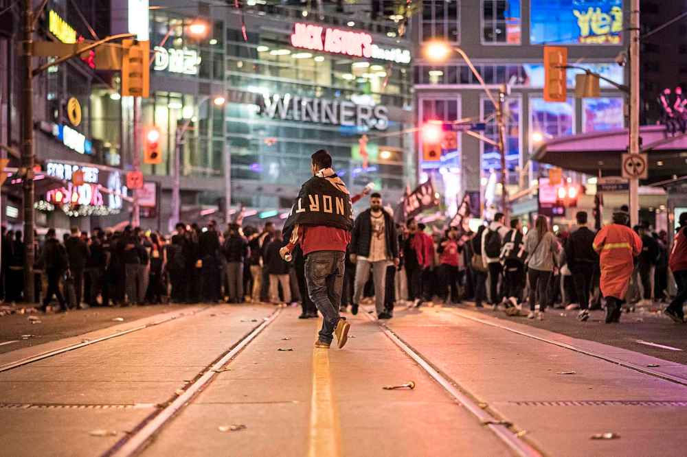 Christopher Katsarov / The Canadian Press
Raptors fans celebrate in the streets of Toronto after the Raptors defeated the Golden State Warriors on Thursday.