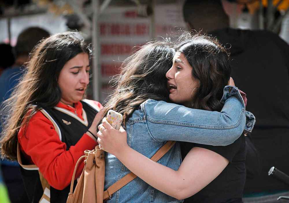 Andrew Lahodynskyj / The Canadian press
Friends embrace after shots were fired.