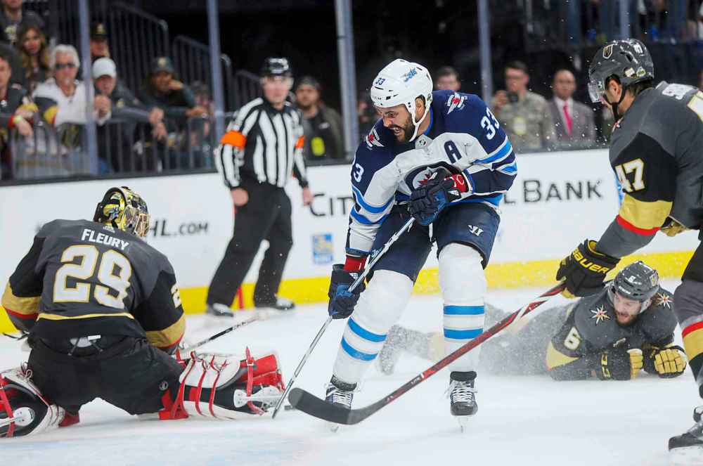 MIKAELA MACKENZIE / WINNIPEG FREE PRESS
Jets defenceman Dustin Byfuglien just misses the net in the third period .