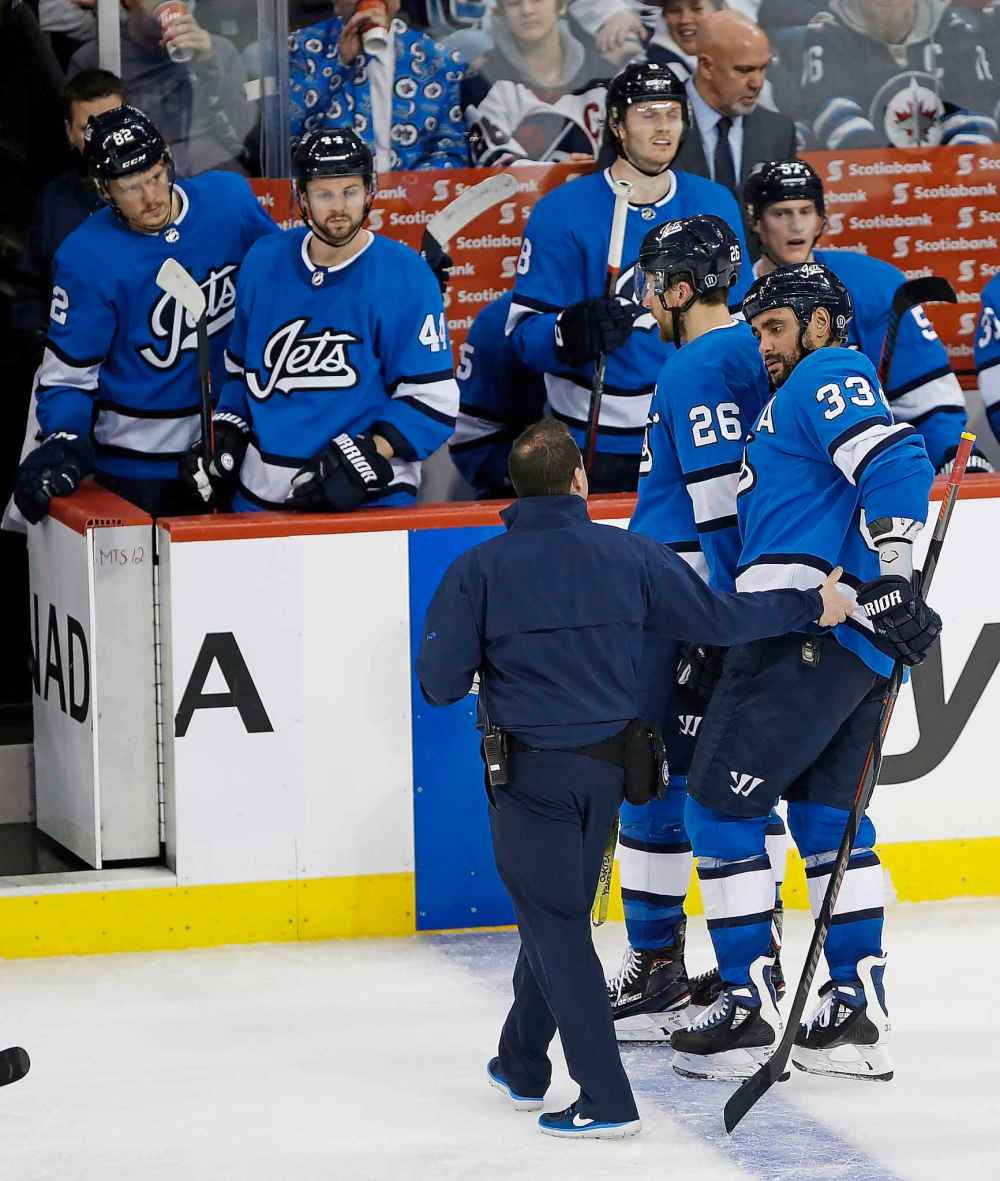 THE CANADIAN PRESS/John Woods
Winnipeg Jets' Dustin Byfuglien is assisted off the ice in December. The big defenceman missed 40 regular-season games due to injury last season.