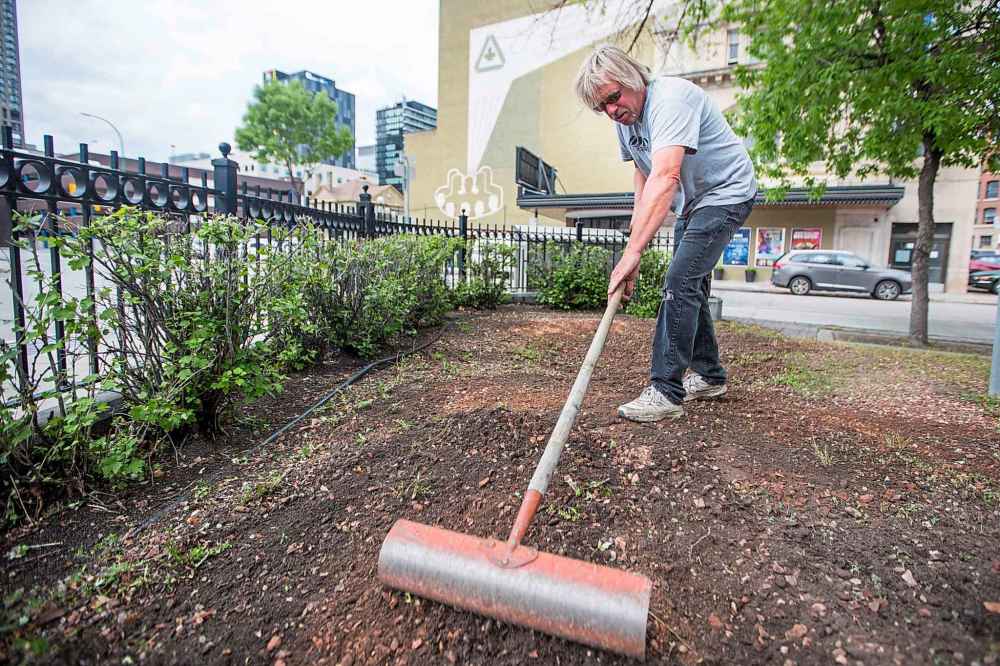 MIKAELA MACKENZIE / WINNIPEG FREE PRESS
Edward Bell, owner/contractor of Bell's Property Services, cleans up the future patio space.