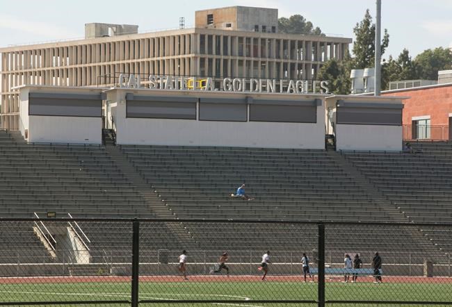 CORRECTS TO ORDER ISSUED LATE WEDNESDAY Students practice track at the Cal State University, Los Angeles campus Thursday, April 25, 2019. A quarantine order was issued late Wednesday for hundreds of students and staff at two Los Angeles universities, including Cal State University, who may have been exposed to measles and either have not been vaccinated or can't verify that they have immunity. (AP Photo/Damian Dovarganes)