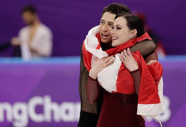Tessa Virtue and Scott Moir of Canada celebrate during the venue ceremony after winning the gold medal in the ice dance, free dance figure skating final in the Gangneung Ice Arena at the 2018 Winter Olympics in Gangneung, South Korea, Tuesday, Feb. 20, 2018. Canadian ice dancing stars Tessa Virtue and Scott Moir say they are