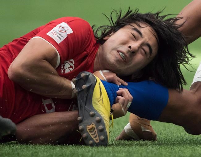 Canada's Nathan Hirayama tackles Samoa's Silao Nonu during World Rugby Sevens Series action, in Vancouver, B.C., on March 11, 2018. The Canadian men downed Guyana in their first match Sunday on Day 2 of the 2019 RF Group RAN (Rugby Americas North) Sevens to move within two wins of qualifying for the Tokyo Olympics. THE CANADIAN PRESS/Jonathan Hayward