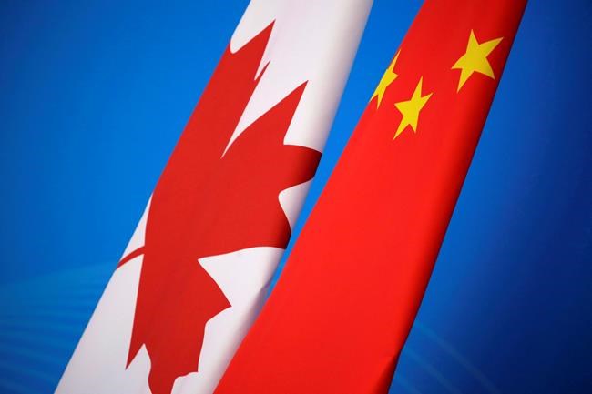 Flags of Canada and China are placed for the first China-Canada economic and financial strategy dialogue in Beijing, China, Monday, Nov. 12, 2018. A Canadian man convicted of drug trafficking in China faces the possibility of more serious charges after a court ordered a new trial amid tensions over Canada's arrest of a Chinese technology executive. THE CANADIAN PRESS/Jason Lee/Pool Photo via AP
