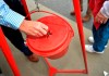 In this Nov. 9, 2018, file photo money gets dropped into the kettle during the Annual Salvation Army Red Kettle and Angel Tree Kick Off outside the Hobby Lobby store in Augusta, Ga. Canada's Salvation Army is testing out a new and faster way to allow cashless donations to its kettle stations via debit and credit card, making the process as quick and easy as dropping a toonie in the bubble. THE CANADIAN PRESS/AP-Michael Holahan/The Augusta Chronicle via AP, File