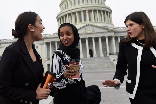 Rep. Alexandria Ocasio-Cortez, D-N.Y., left, talks with Rep. Ilhan Omar, D-Minn., center, and Rep. Haley Stevens, D-Mich., right, as they head to a group photo with the women of the 116th Congress on Capitol Hill in Washington, Friday, Jan. 4, 2019. Americans elected 36 new female faces in last year's midterm elections - most of them Democrats in the House of Representatives - in what proved to be the most ethnically diverse and women-centric freshman class in the history of Congress, which now boasts the most women members in its history, including the first Muslim and Indigenous women ever elected to sit in the chamber.THE CANADIAN PRESS/AP/Susan Walsh