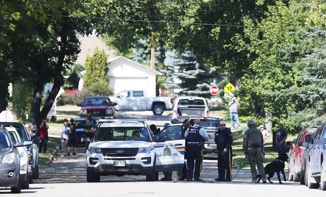 The RCMP emergency response unit arrests an alleged suspect in Neepawa, Man., on August 30, 2018, following the shooting of a RCMP officer in Onanole, Man. A Manitoba man who shot at two RCMP officers and left one with severe injuries has been given an 18-year prison sentence. Therae Racette-Beaulieu was sentenced after pleading guilty earlier this year to charges of attempted murder, break and enter, and robbery in connection with a string of crimes in western Manitoba last summer. THE CANADIAN PRESS/John Woods