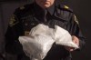 An OPP officer displays bags containing fentanyl as Ontario Provincial Police host a news conference in Vaughan, Ont., on February 23, 2017. Canada's chief public health officer says the need to increase access to a 