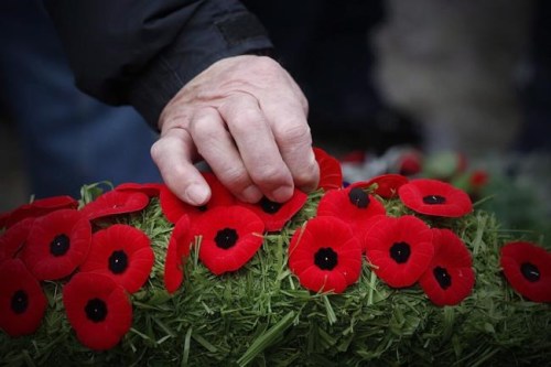 Poppies are placed on a wreath at a cenotaph during a Remembrance Day service in Winnipeg, Saturday, Nov. 11, 2017. Canadians will gather at cenotaphs and monuments across the country this morning to remember and honour those who took up arms ??? and in some cases paid the ultimate price ??? to defend this country and its way of life.THE CANADIAN PRESS/John Woods