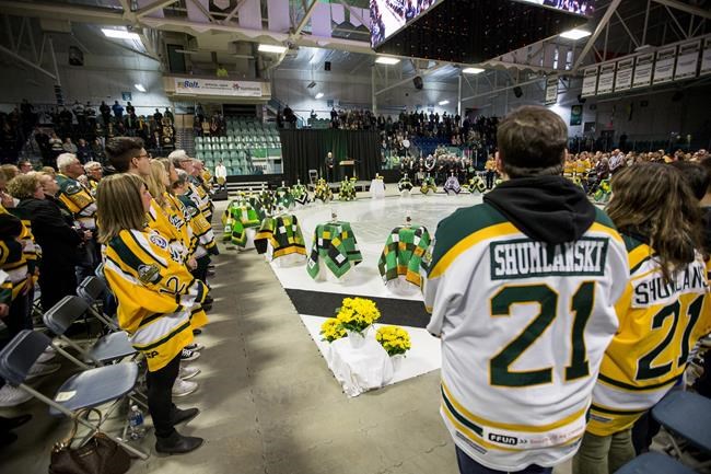 Family members and community members join in a moment of silence during the Humboldt Broncos memorial service at Elgar Petersen Arena in Humboldt, Saskatchewan on Saturday, April, 6, 2019. One year ago today, sixteen people were killed and 13 were injured after the Saskatchewan hockey team's bus collided with a semi driven by a novice trucker who had blown the stop sign at a rural intersection.THE CANADIAN PRESS/POOL-Liam Richards