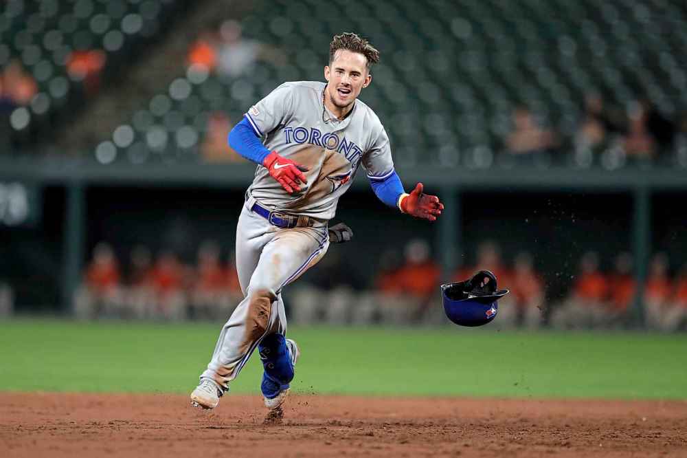 Players will run through walls to follow Cavan  Biggio. (Julio Cortez / Associated Press files)