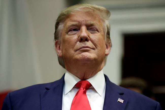 President Donald Trump winks as he listens before a trade agreement signing with Japan in the Roosevelt Room of the White House, Monday, Oct. 7, 2019, in Washington. (AP Photo/Evan Vucci)