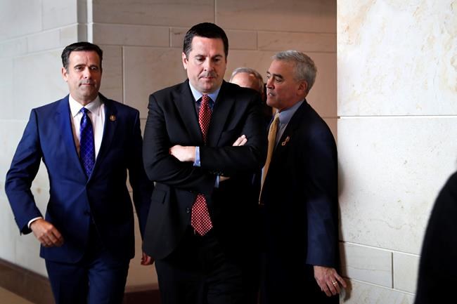 Rep. John Ratcliffe R-Texas, left, and House Intelligence Committee Ranking Member Devin Nunes, R-Calif., center, leave a closed-door meeting of the House Intelligence Committee with testimony from Michael Cohen, President Donald Trump's former personal lawyer, Monday, Feb. 5, 2018, to attend a vote on Capitol Hill in Washington. (AP Photo/Jacquelyn Martin)