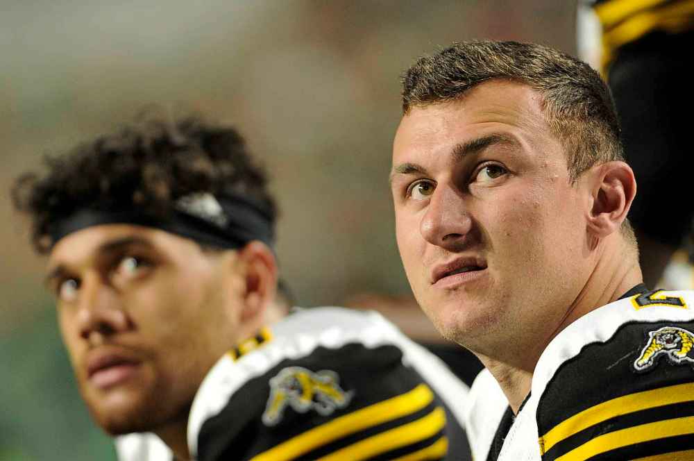 Mark Taylor / THE CANADIAN PRESS
Hamilton Tiger-Cats quarterback Jeremiah Masoli, left, and backup Johnny Manziel watch the scoreboard during second half CFL action at Mosaic Stadium in Regina on Thursday, July 5, 2018.