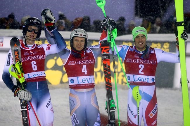 Norway's Henrik Kristoffersen, center, winner of an alpine ski, men's slalom, poses with second placed France Clement Noel, left, and third place Switzerland's Daniel Yule, in Levi, Finland, Sunday, Nov. 24, 2019. (AP Photo/Alessandro Trovati)