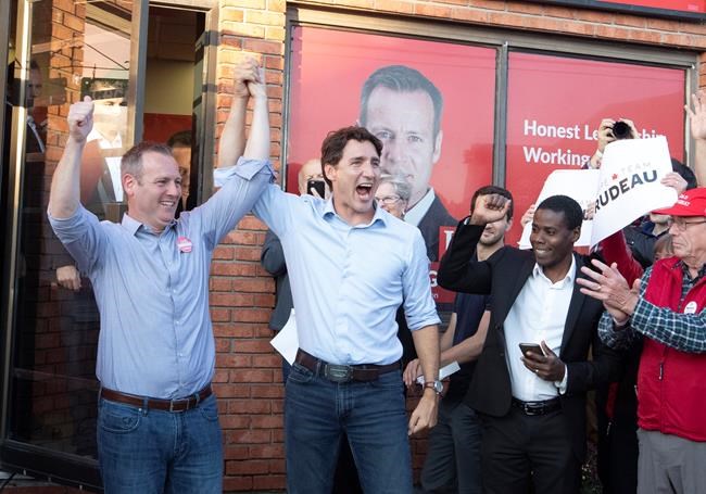 Prime Minister Justin Trudeau raises the arm of Carleton Liberal candidate Chris Rogers (left) attends as he attends and election campaign event in Manotick, Ontario, Monday September 9,2019. THE CANADIAN PRESS/Fred Chartrand