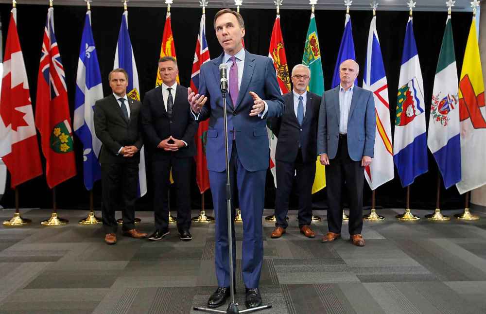 Patrick Doyle / The Canadian Press
Finance Minister Bill Morneau speaks to reporters with Manitoba Finance Minister Cameron Friesen, left, PEI Finance Minister Heath MacDonald, second from left, Quebec Finance Minister Carlos Leitao, second from right, and Newfoundland and Labrador Finance Minister Tom Osborne, right, after a meeting with provincial and territorial finance ministers in Ottawa.