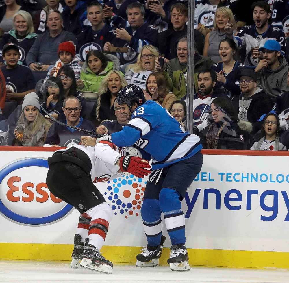 Trevor Hagan / The Canadian Press files
Winnipeg Jets' Dustin Byfuglien (33) grapples with New Jersey Devils' Ben Lovejoy (12) during second period NHL hockey action in Winnipeg, Sunday, November 11, 2018.