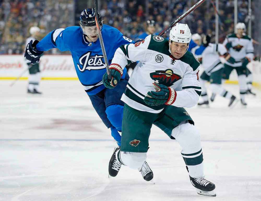 John Woods / The Canadian Press files
Jacob Trouba can't stop Matt Hendricks (as a Minnesota Wild player) during a tilt in December.