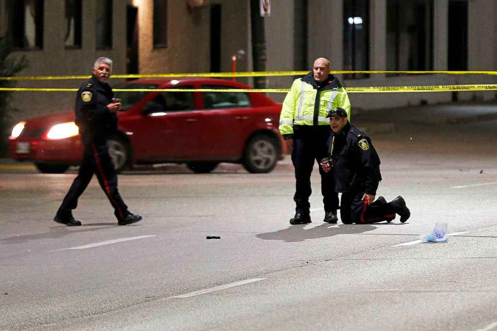 Police investigate the scene of the collision that killed pedestrian Cody Severight on Main Street in October 2017. (John Woods / Winnipeg Free Press files)