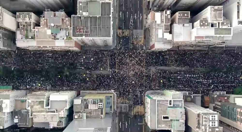 Cable TV Hong Kong via AP
Protesters fill the Hennesy Road in Hong Kong, Sunday.