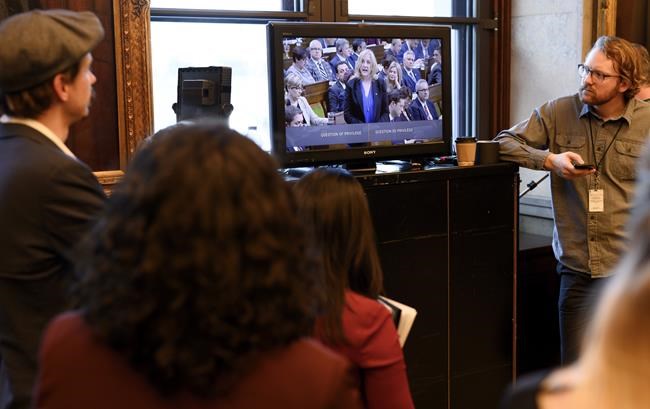 Reporters and political staffers watch a live stream of Conservative MP Lisa Raitt from inside the House of Commons during the tabling of the federal budget in Ottawa on Tuesday, March 19, 2019. THE CANADIAN PRESS/Justin Tang