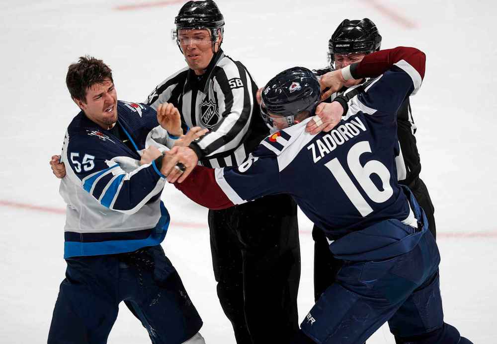 (AP Photo/David Zalubowski)
Winnipeg Jets centre Mark Scheifele, left, is restrained by the linesmen as Colorado Avalanche defenceman Nikita Zadorov squares off to fight in the third period.