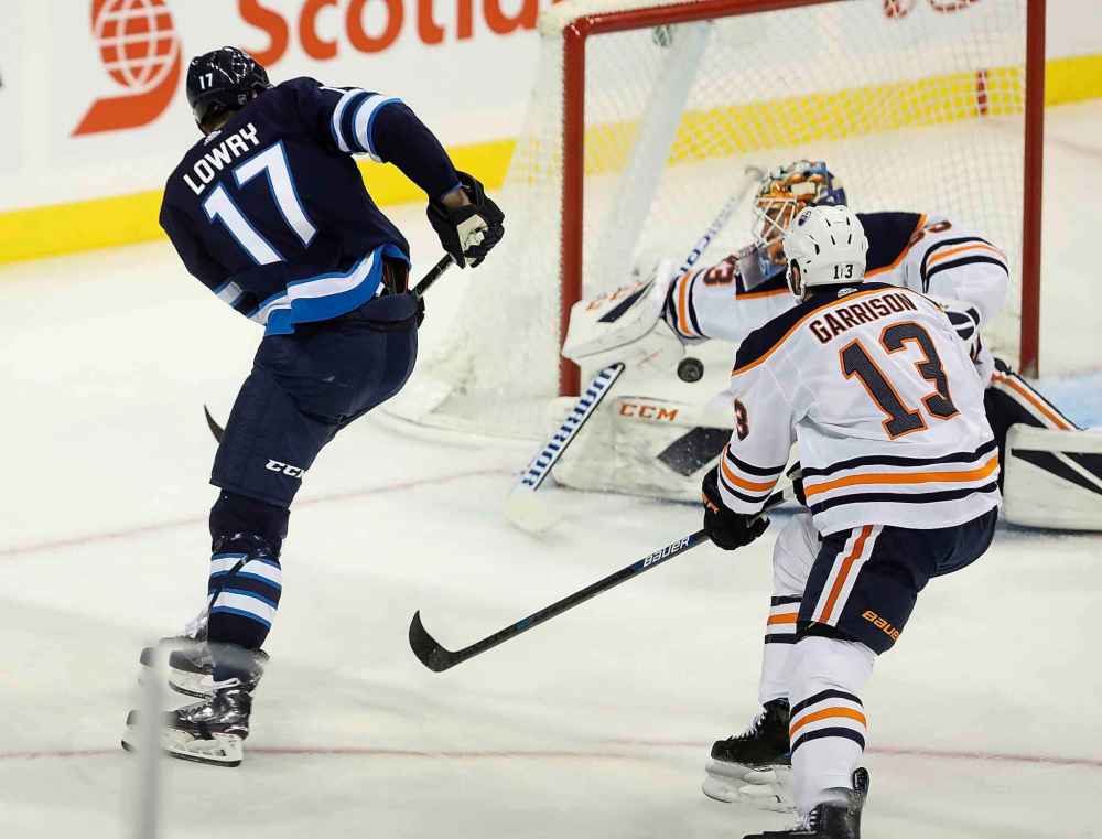 THE CANADIAN PRESS/Trevor Hagan
Winnipeg Jets' Adam Lowry scores his second goal of the game against Edmonton Oilers' goaltender Cam Talbot during first period.