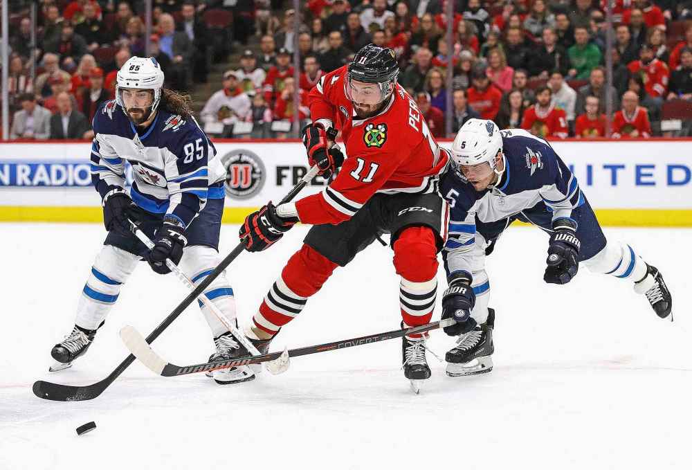 Jonathan Daniel / Getty Images / TNS
Mathieu Perreault, left, and Dmitry Kulikov, right, each make more than $4M per season and would be prime candidates for the Jets to trade if they needed to dump some salary heading into free agency season.