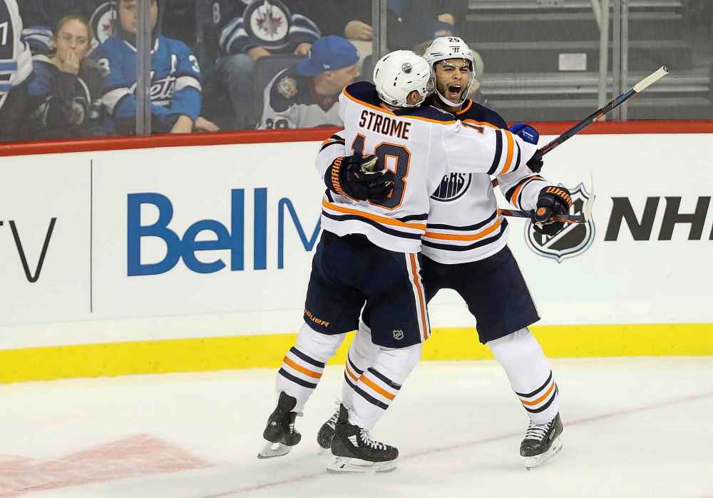 THE CANADIAN PRESS/Trevor Hagan
Edmonton Oilers' Ryan Strome and Darnell Nurse celebrate after Nurse scored the game winning goal in overtime Tuesday.