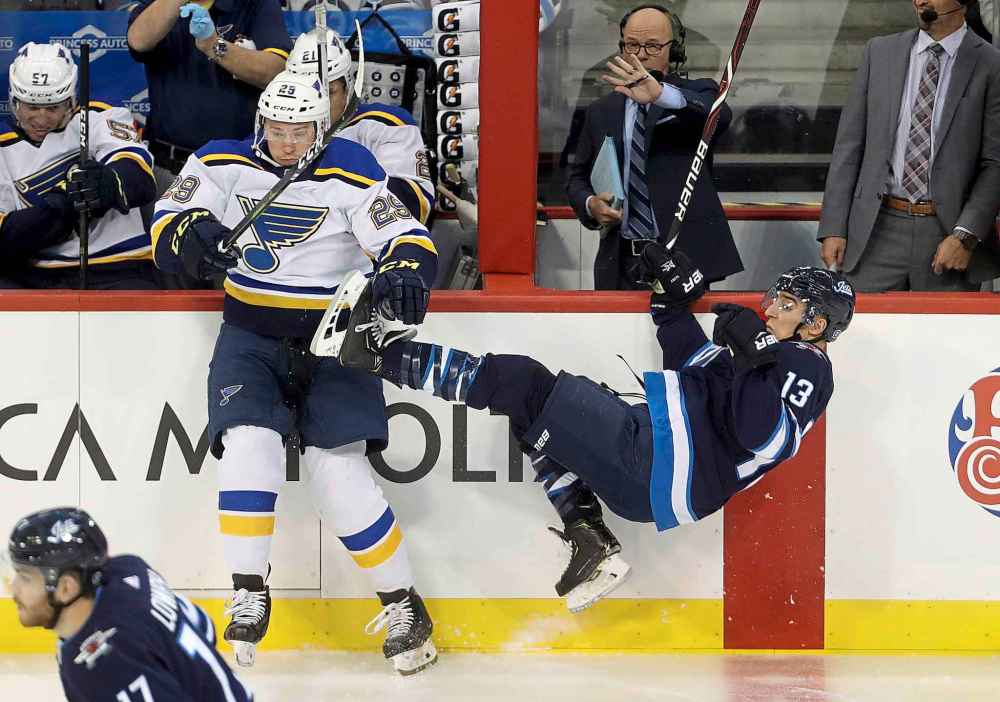THE CANADIAN PRESS/Trevor Hagan
St. Louis Blues' Vince Dunn hits Winnipeg Jets' Brandon Tanev during the first period.