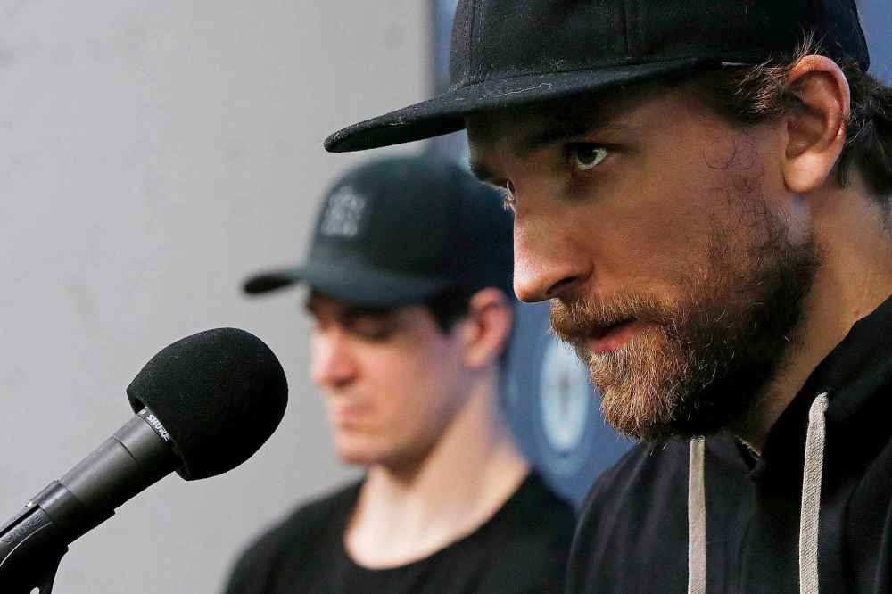 THE CANADIAN PRESS/John Woods
Winnipeg Jets' Mark Scheifele, left, beside team captain Blake Wheeler on the podium Monday in near-silence, allowing Wheeler to answer almost all questions.