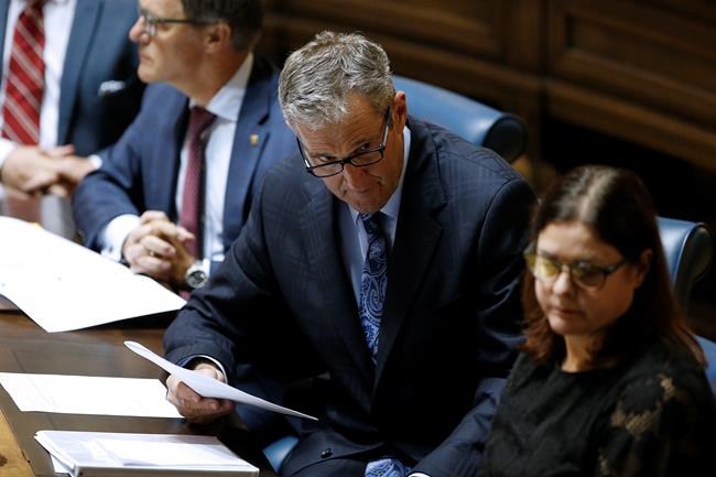 Manitoba Premier Brian Pallister talks to ministers after the reading of the Speech from the Throne at the Manitoba Legislature in Winnipeg, Monday, September 30, 2019. THE CANADIAN PRESS/John Woods