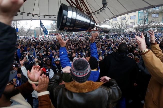 Winnipeggers are crowding the downtown streets Tuesday, Nov. 26, 2019, to celebrate as Andrew Harris raises the cup to the end of a Grey Cup drought that lasted almost three decades. The city is hosting a parade this afternoon after the Winnipeg Blue Bombers won their 11th Grey Cup with a 33-12 victory over the Hamilton Tiger-Cats on Sunday in Calgary. THE CANADIAN PRESS/John Woods
