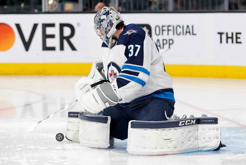 Last season, the Winnipeg Jets did a good job of keeping the shots to the perimeter, and Connor Hellebuyck usually made the save. (John Locher / The Associated Press files)