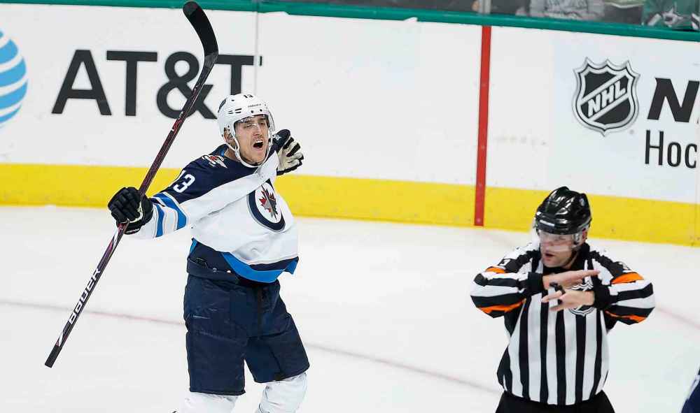 Brandon Wade / The Associated Press files
Winnipeg Jets forward Brandon Tanev (13) reacts as referee Chris Schlenker (3) waves off his goal for goaltender interference during the first period of an NHL hockey game against the Dallas Stars, Saturday, Oct. 6, 2018, in Dallas.