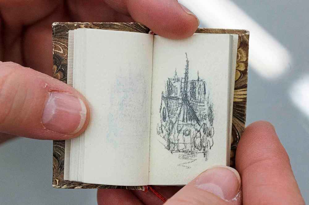 MIKE DEAL / WINNIPEG FREE PRESS
Artist Wanda Koop in her Winnipeg Studio with one of the ten sketch books she carried with her that she filled with drawings of the Notre Dame Cathedral during her six-month Canada Council Paris Studio trip.
190416 - Tuesday, April 16, 2019.