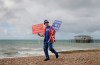 Anti Brexit campaigner Steve Bray walks on the beach to pose for a photograph during the Labour Party Conference at the Brighton Centre in Brighton, England, Monday, Sept. 23, 2019. (AP Photo/Kirsty Wigglesworth)