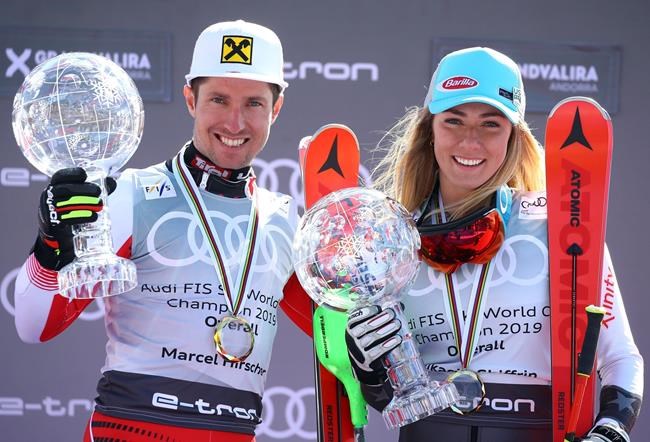 FILE - In this Sunday, March 17, 2019 file photo, Austria's Marcel Hirscher, left, and United States' Mikaela Shiffrin hold the World Cup overall trophies, at the alpine ski finals in Soldeu, Andorra. A new Alpine ski season starts this month, Oct. 2019, with Mikaela Shiffrin the expected superstar and China poised to be a surprise success. Shiffrin is the sport’s most bankable star after Lindsey Vonn, Marcel Hirscher, and Aksel Lund Svindal all retired. (AP Photo/Alessandro Trovati, File)