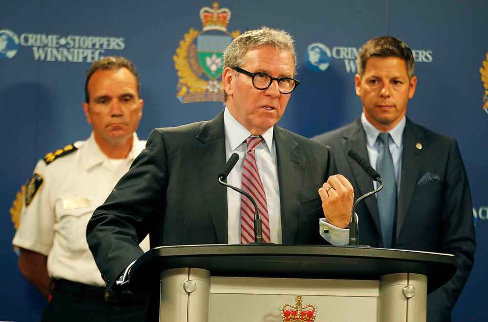 PHIL HOSSACK / WINNIPEG FREE PRESS
Winnipeg Police Board Chair David Asper, flanked by Police Chief Danny Smyth, left and Mayor Brian Bowman at the Monday morning press briefing.