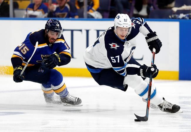 Winnipeg Jets' Tyler Myers (57) handles the puck as St. Louis Blues' Robby Fabbri (15)pursues during the second period in Game 6 of an NHL first-round hockey playoff series, Saturday, April 20, 2019, in St. Louis. (AP Photo/Jeff Roberson)