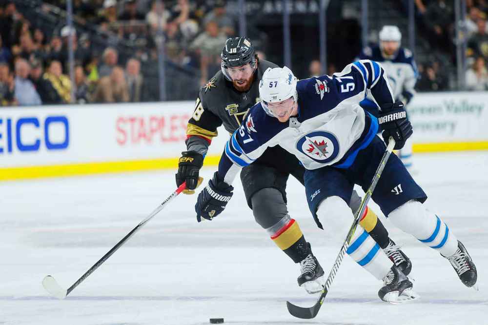 MIKAELA MACKENZIE / WINNIPEG FREE PRESS
Jets defenceman Tyler Myers and Knights forward James Neal race for the puck in the third period.