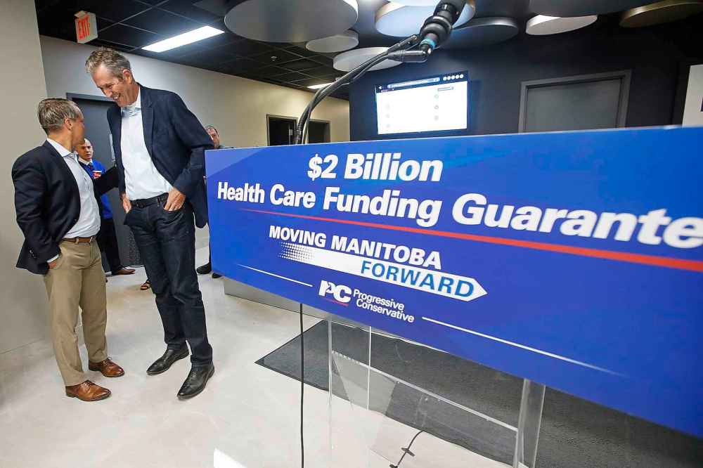 John Woods / The Canadian Press
Manitoba PC leader and premier Brian Pallister jokes with Manitoba Health Minister Cameron Friesen after a press conference at a medical clinic in Winnipeg.
