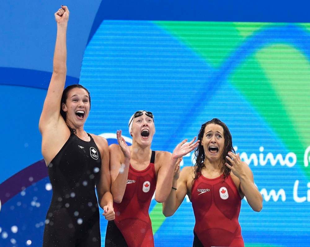 Frank Gunn
/ The Canadian Press
The Canadian women's 4x100-metre freestyle relay team Chantal Van Landeghem, left to right, Taylor Ruck, Sandrine Manville and Penny Oleksiak (not shown), celebrate their bronze medal finish at the 2016 Summer Olympics, in Rio de Janeiro, Brazil, Saturday, Aug. 6, 2016.